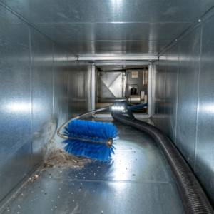 Industrial air duct cleaning with rotating brush and HEPA vacuum inside metallic HVAC ducts, realistic lighting, highly detailed, no people
