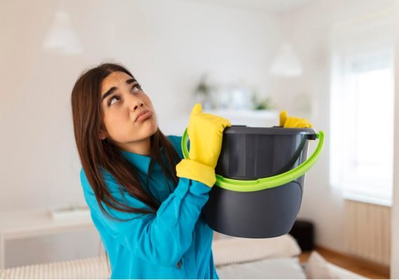 A-woman-collect-water-from-an-AC-Leaking-Water-