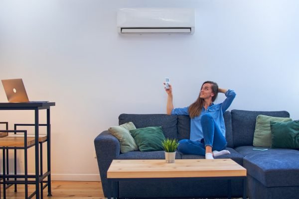 a-woman-relaxes-below-a-quite-air-conditioners